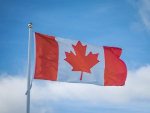 A Canadian flag flying against the sky